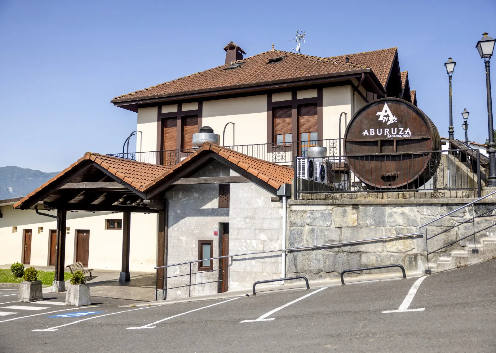 The Aburuza cellar building in Aduna, with a large cask bearing the house name beside the entrance