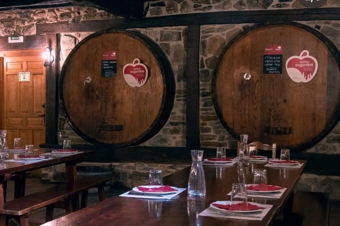 Iturrieta's wooden kupelas beside the cider house's long tables