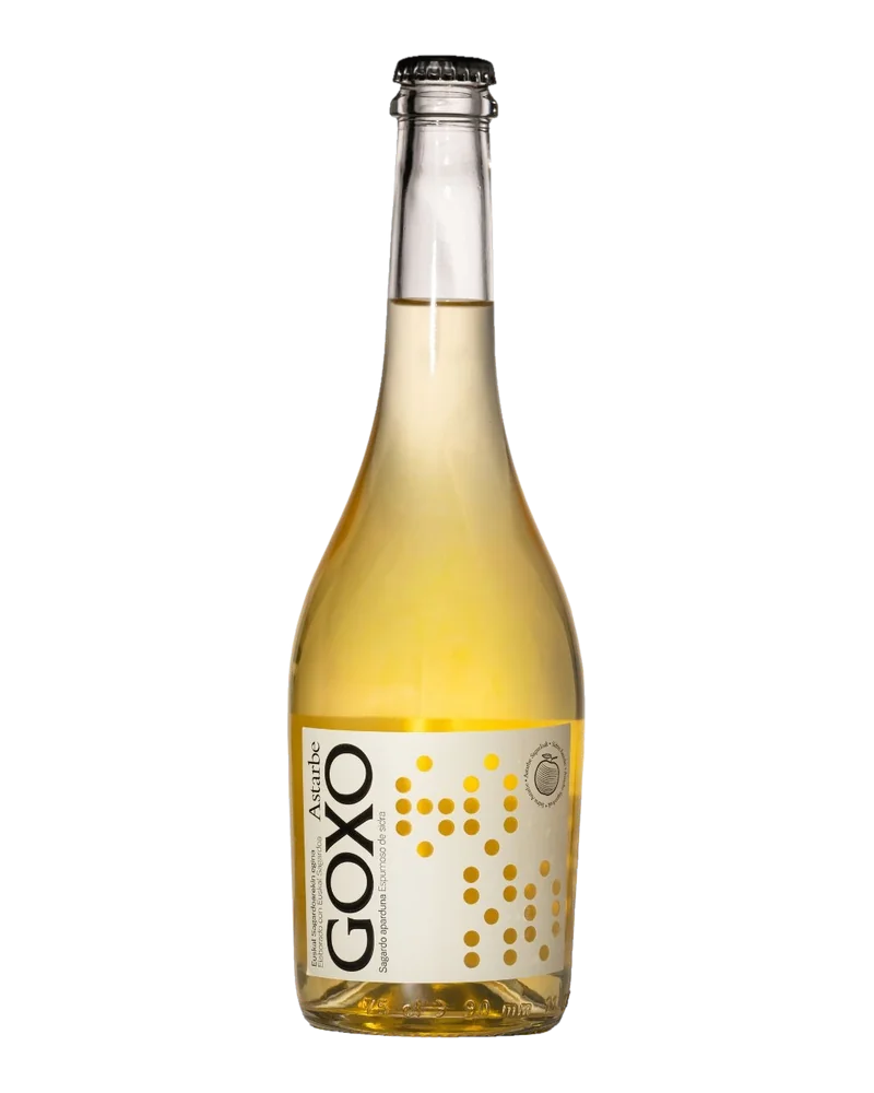 Clear bottle of Astarbe Goxo sparkling cider, with a white label dotted in gold