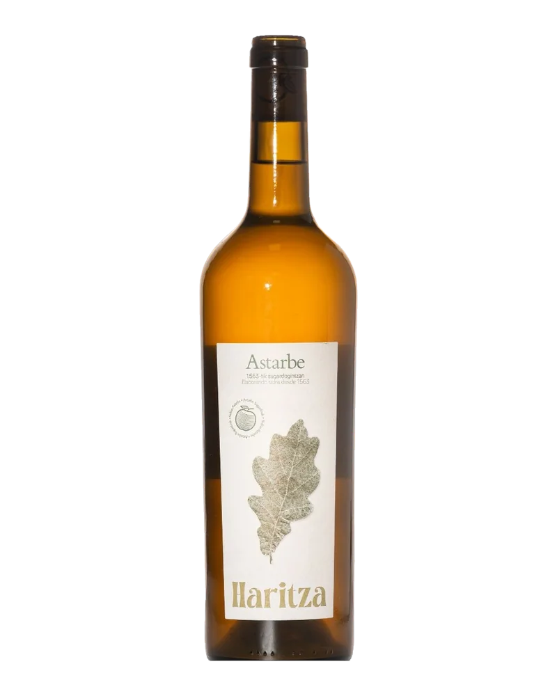 Bottle of Astarbe Haritza cider in amber glass, with a white label showing an oak leaf
