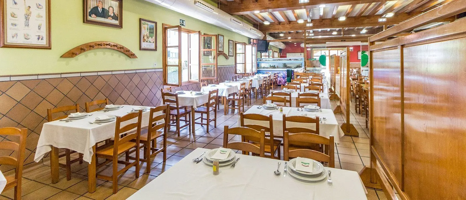 Dining room of the cider bar with tables laid in white