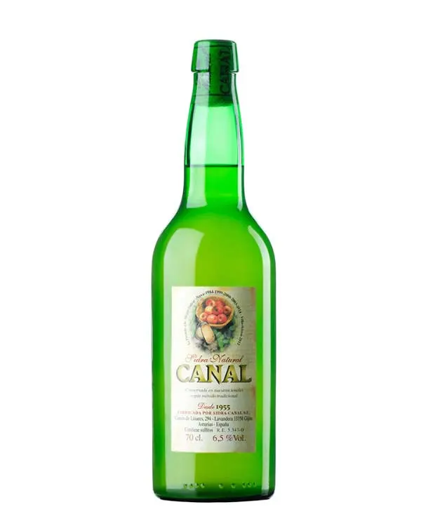 Bottle of Canal natural cider with a pale label and a basket of apples
