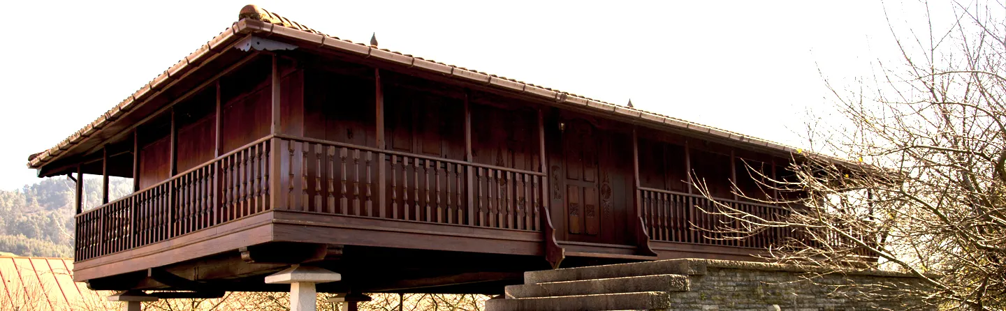 Wooden Asturian panera (raised granary) at the entrance to the cider mill