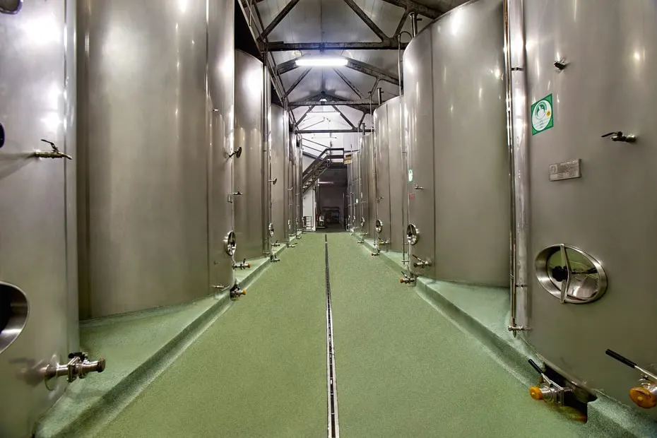 Aisle between stainless steel tanks for fermenting the must